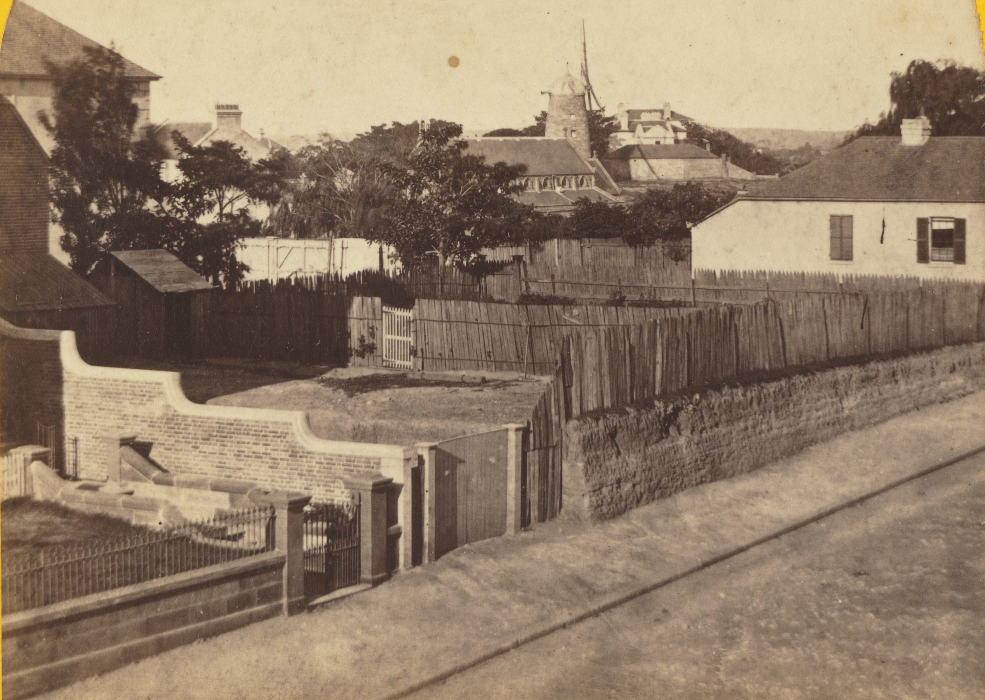 Photograph showing a windmill and houses